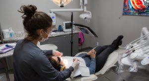 Patient in dental chair receiving treatment for gum disease